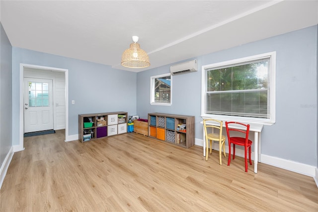 6619 Livingston Ave N, Saint Petersburg, FL 33702 - rec room featuring baseboards, wood finished floors, and an AC wall unit