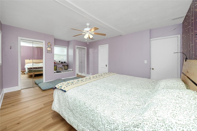 6619 Livingston Ave N, Saint Petersburg, FL 33702 - bedroom with a ceiling fan, light wood-type flooring, baseboards, beamed ceiling, and two closets