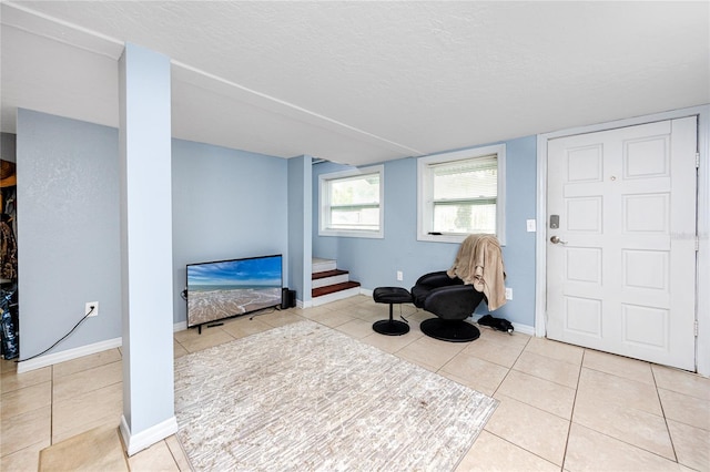 6619 Livingston Ave N, Saint Petersburg, FL 33702 - living area featuring baseboards, stairs, a textured ceiling, and tile patterned floors