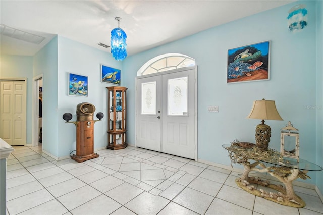 entrance foyer with light tile patterned flooring and french doors