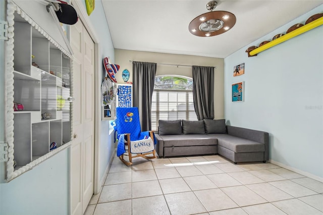 living area featuring light tile patterned floors and a chandelier