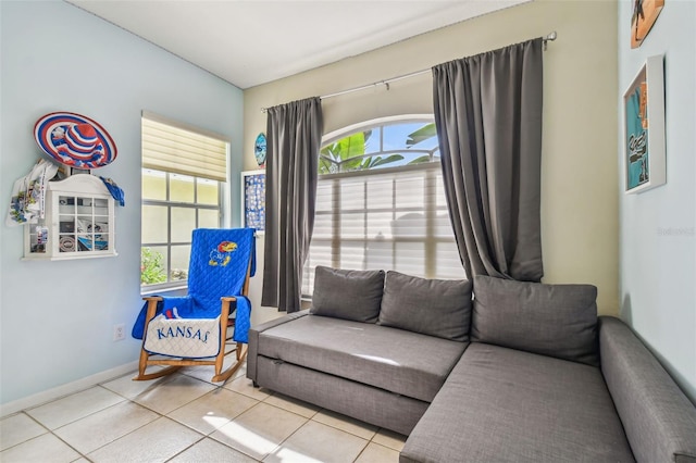 living room with tile patterned floors, plenty of natural light, and baseboards