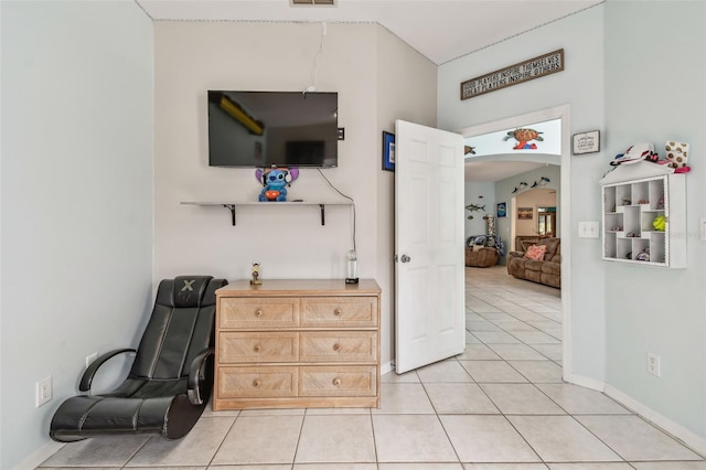 sitting room with light tile patterned flooring, baseboards, arched walkways, and visible vents
