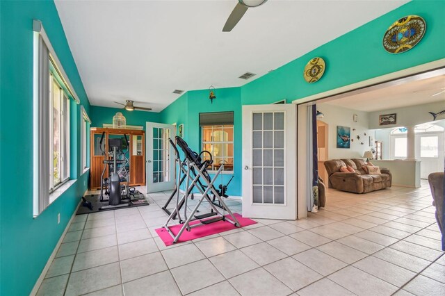 exercise room featuring ceiling fan, plenty of natural light, and light tile patterned floors