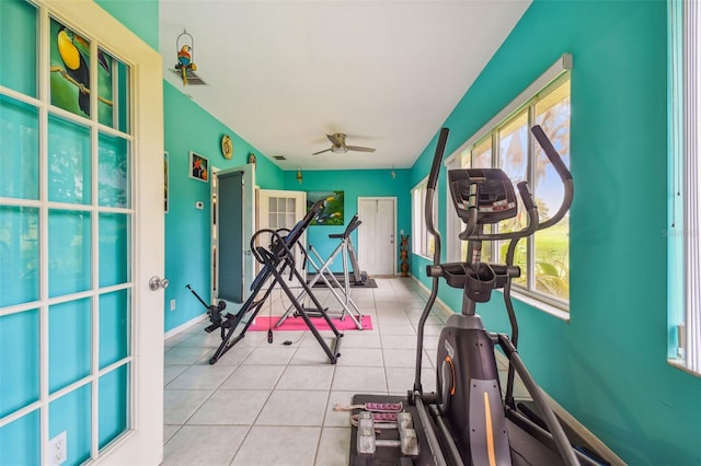 workout room featuring a ceiling fan, tile patterned flooring, plenty of natural light, and baseboards