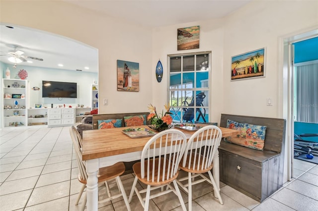 tiled dining area with ceiling fan