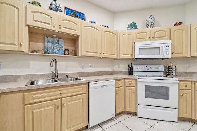 kitchen featuring white appliances, light brown cabinetry, light tile patterned flooring, and sink