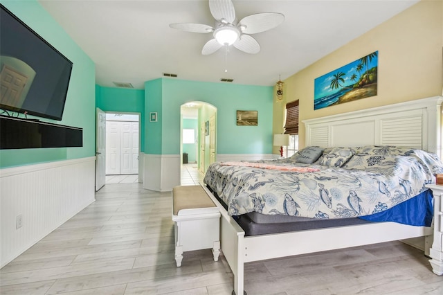 bedroom with a closet, light hardwood / wood-style floors, and ceiling fan