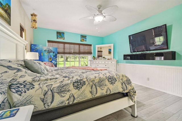 bedroom with light hardwood / wood-style floors and ceiling fan