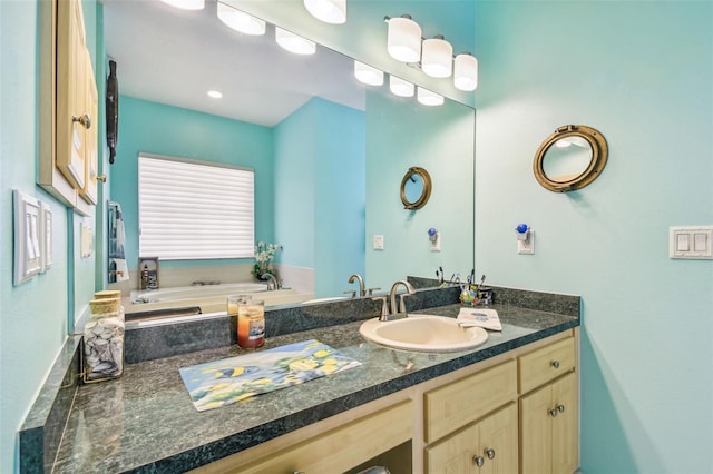 bathroom with a tub to relax in and vanity