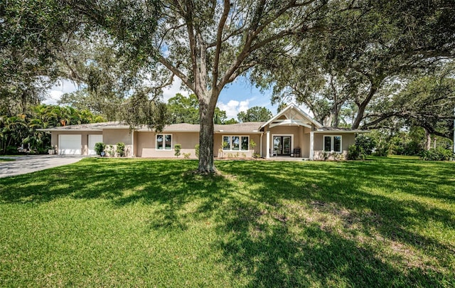 single story home featuring a garage and a front lawn