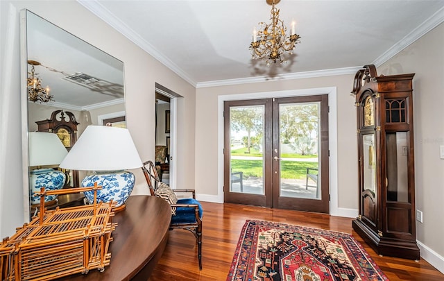 foyer with ornamental molding, french doors, a chandelier, and dark hardwood / wood-style floors