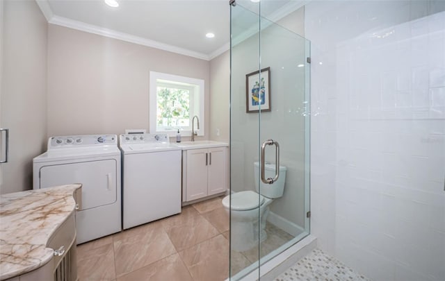 bathroom with crown molding, vanity, a shower with shower door, and independent washer and dryer