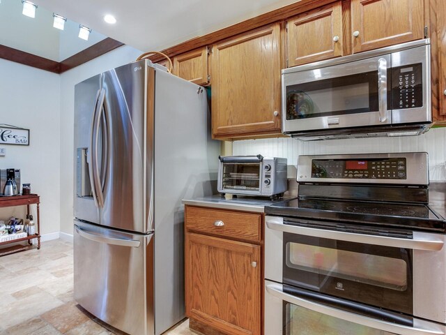 kitchen with appliances with stainless steel finishes and tasteful backsplash