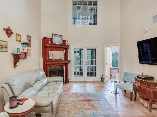 living room with a towering ceiling and french doors