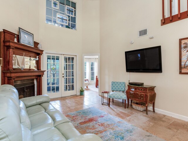 living room with a high ceiling and french doors