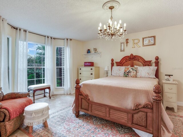 bedroom with multiple windows, a textured ceiling, and a chandelier