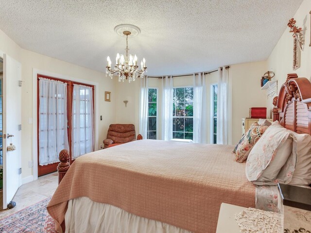 tiled bedroom with a textured ceiling and a notable chandelier