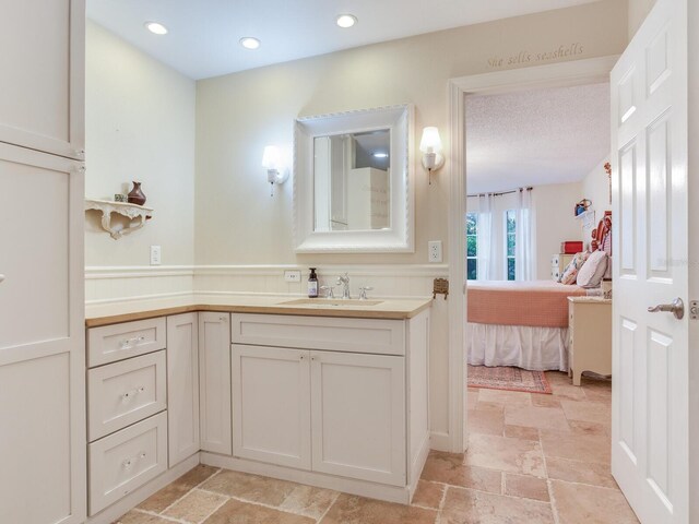 bathroom featuring vanity and a textured ceiling