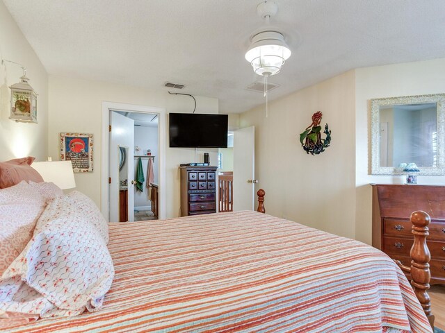 bedroom with a textured ceiling and hardwood / wood-style flooring