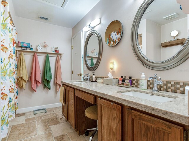 bathroom with vanity and backsplash