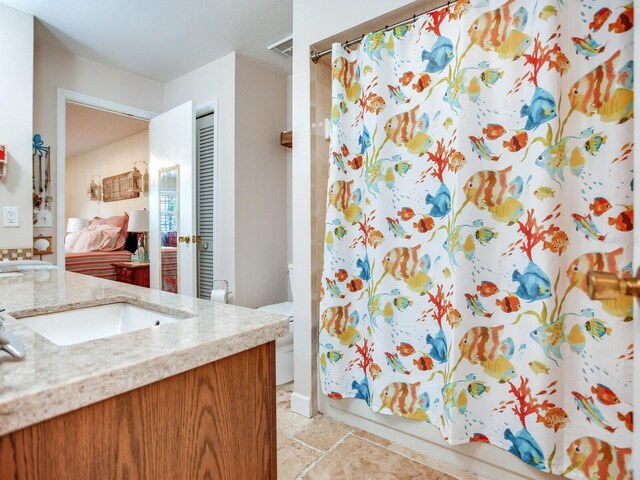 full bathroom with vanity, toilet, tile patterned floors, and shower / bath combo