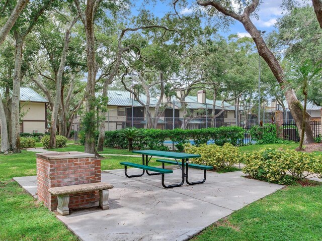 view of home's community with a yard and a patio area