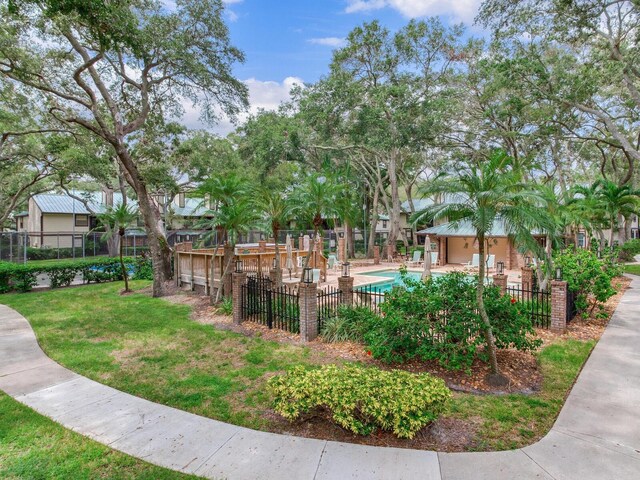 exterior space with a yard and a swimming pool