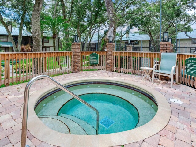 view of pool featuring a hot tub and a patio