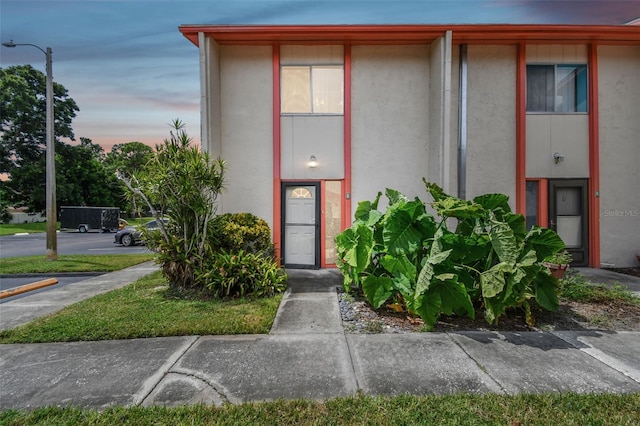 1655 58th Ter S Unit 1, Saint Petersburg, FL 33712 - property entrance featuring stucco siding and uncovered parking
