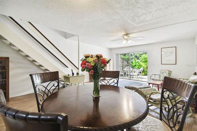 1655 58th Ter S Unit 1, Saint Petersburg, FL 33712 - dining area featuring wood finished floors, a textured ceiling, stairway, and ceiling fan