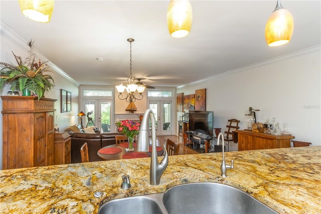 kitchen featuring ornamental molding, sink, and french doors