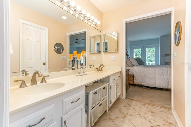 bathroom with tile patterned flooring, vanity, and ceiling fan