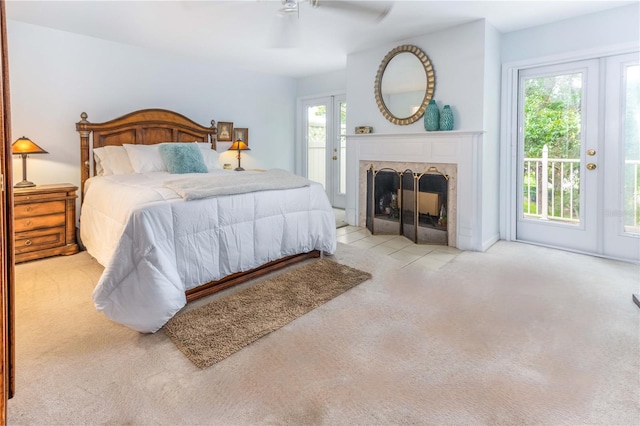 carpeted bedroom with ceiling fan and access to exterior