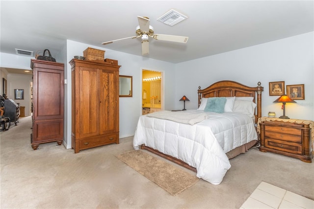 bedroom featuring ensuite bath, ceiling fan, and light carpet