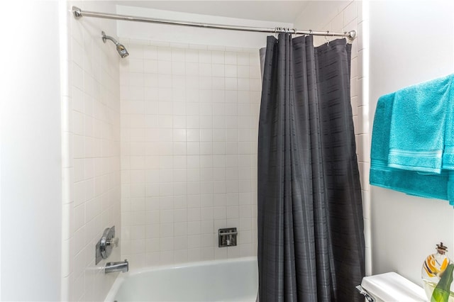 bathroom featuring shower / bath combo and toilet