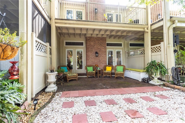 property entrance with a balcony and french doors