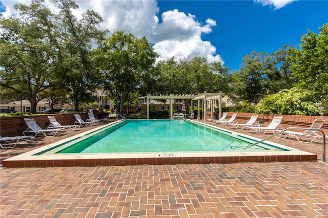 view of swimming pool with a pergola and a patio