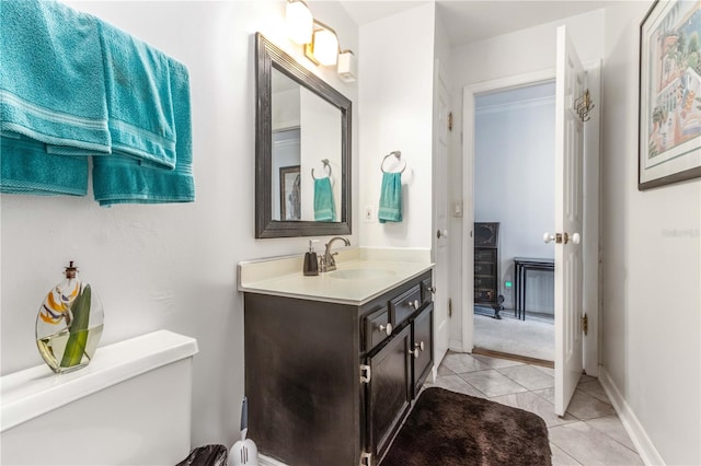 bathroom featuring tile patterned flooring, vanity, and toilet