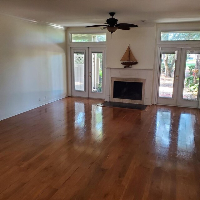 unfurnished living room with hardwood / wood-style floors, ornamental molding, french doors, and ceiling fan