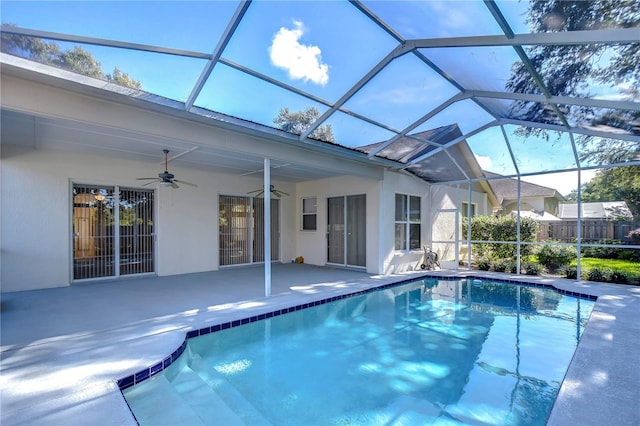 view of pool featuring a lanai, a patio, and ceiling fan