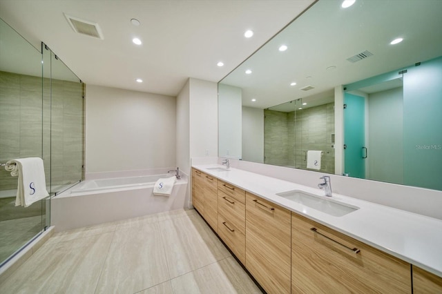 bathroom featuring tile patterned flooring, vanity, and separate shower and tub