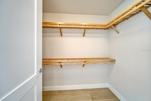 spacious closet with light hardwood / wood-style floors