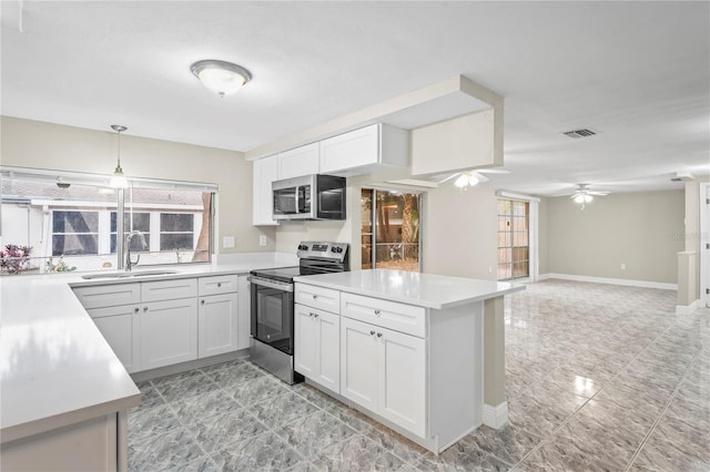 kitchen with ceiling fan, sink, white cabinets, pendant lighting, and stainless steel appliances