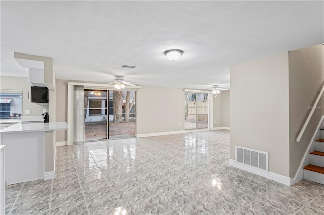 unfurnished living room featuring ceiling fan