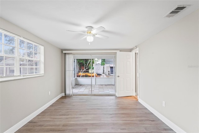 unfurnished room featuring light wood-type flooring and ceiling fan