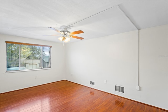 spare room with ceiling fan and wood-type flooring