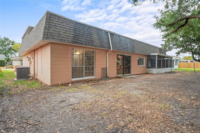 back of house featuring a sunroom and central AC