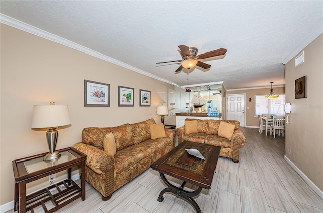 living room with ceiling fan, a textured ceiling, and ornamental molding