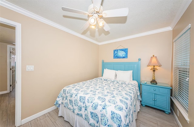 bedroom featuring ceiling fan, crown molding, and a textured ceiling